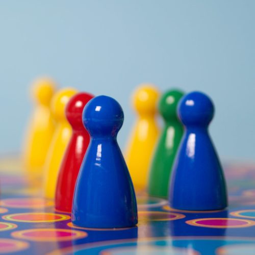 closeup photography of yellow red green and blue chess piece